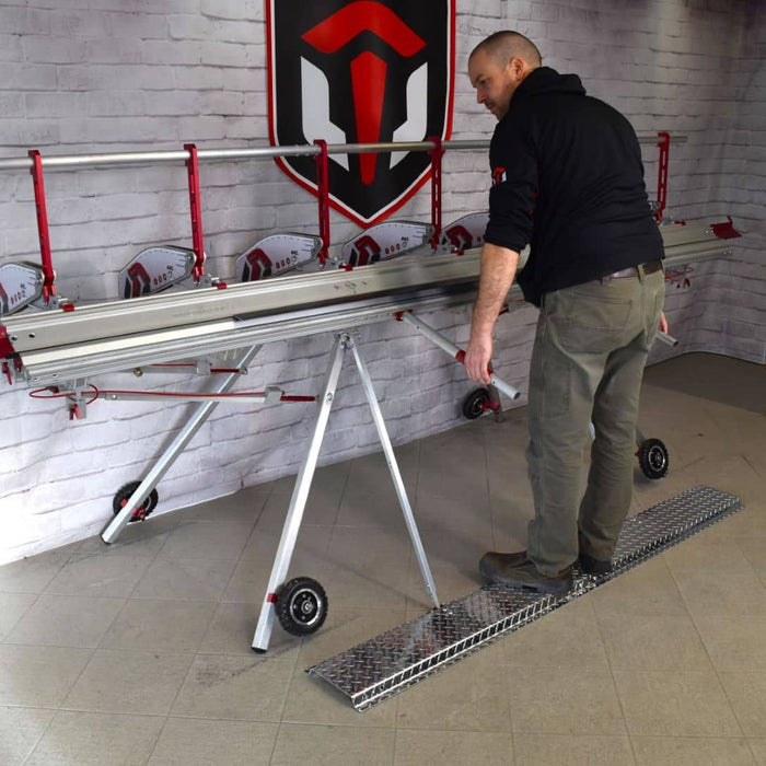 User performing an bend using an Innoivatools aluminum brake while standing on the Stabilizing Step Platform