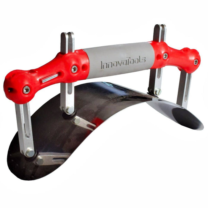 A radius adjustadle curved trowel blade with semi-circle ends, four adjustment pillars and a red plastic handle with a grey grip area